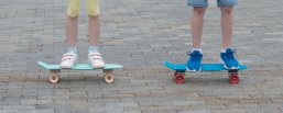 Kinder auf Skateboards Zwei Kinder fahren Skateboard